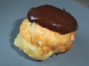 Photo d'une profiterole fourrée crème pâtissière et nappée chocolat